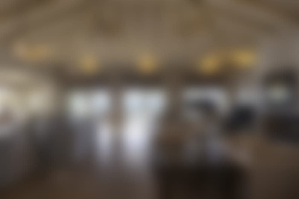 Villa Marlina's roomy, open-plan living and dining area with its lofty wood-beamed ceilings.